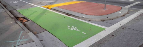 A green painted bike lane and a protected intersection
