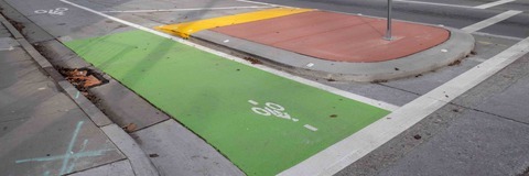 A green painted bike lane and a protected intersection