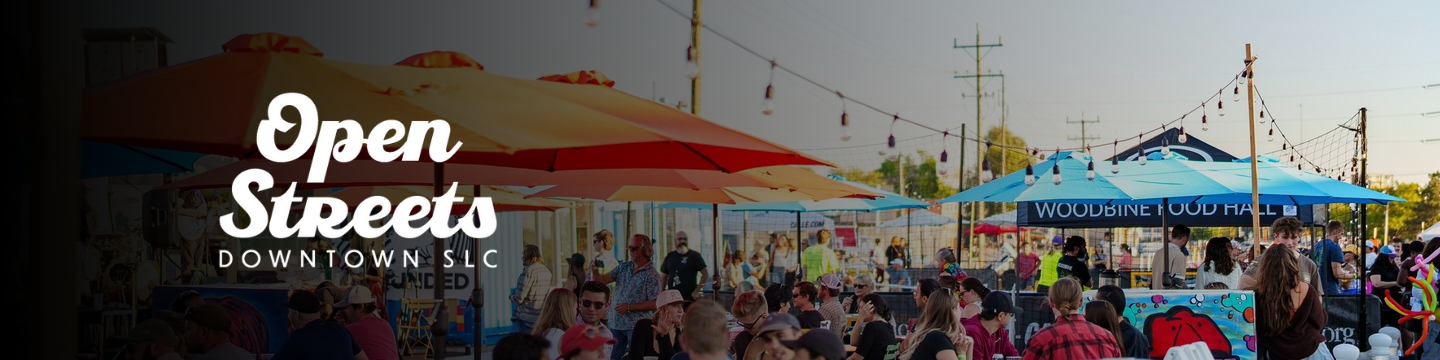 People sitting at tables talking at Open Streets 2024