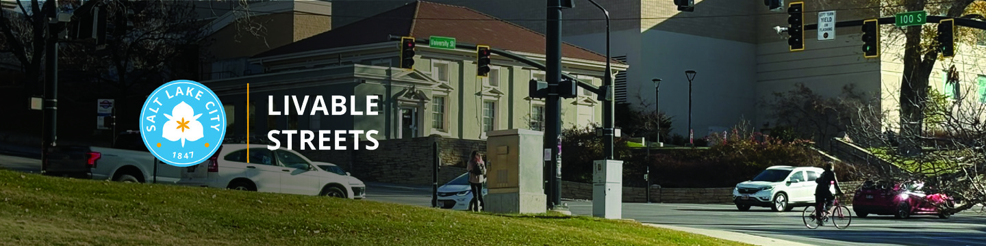 The Salt Lake City logo, a yellow vertical line, and text reading "Livable Streets" are in the foreground. Image of an intersection with vehicles, pedestrians, and bicycles.